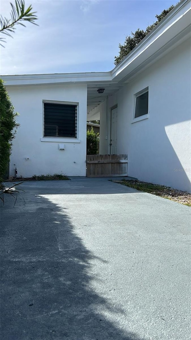 view of exterior entry featuring a carport