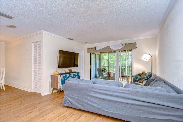 bedroom featuring crown molding, access to outside, a textured ceiling, visible vents, and wood finished floors