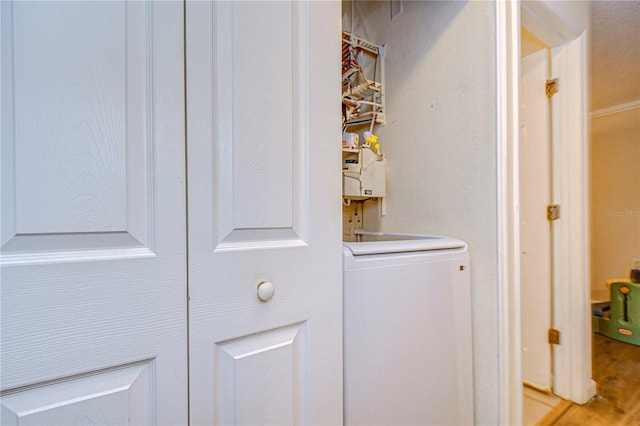 laundry room with light wood-style flooring and washer / dryer