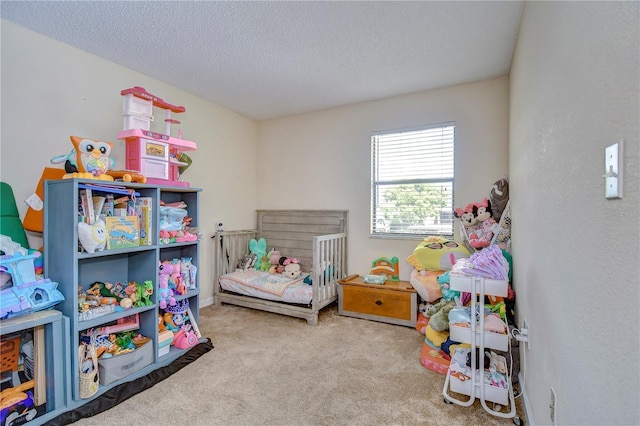 carpeted bedroom with a textured ceiling and a crib