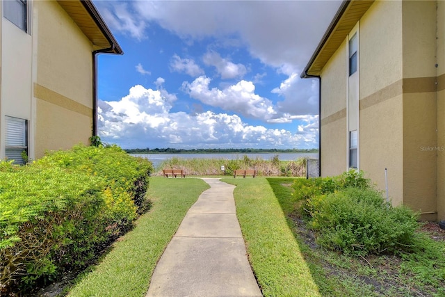 exterior space featuring a water view and a yard