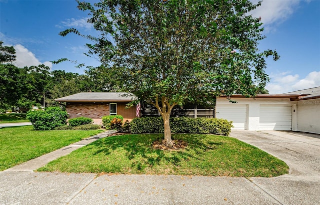 ranch-style home with a garage and a front lawn