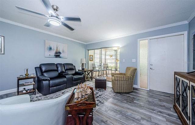 living room with wood-type flooring, crown molding, and ceiling fan