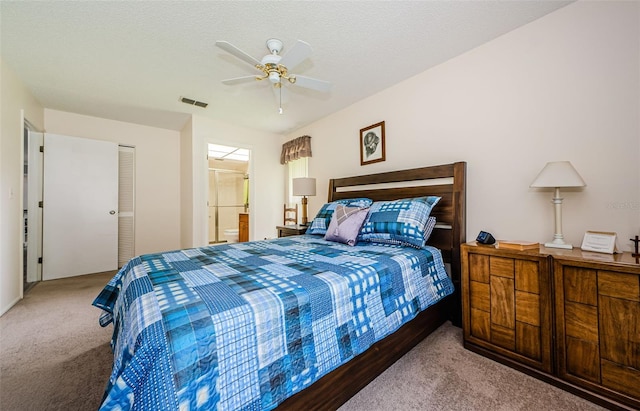 carpeted bedroom featuring ceiling fan, a textured ceiling, and a closet