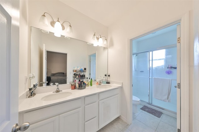 bathroom featuring tile patterned flooring, vanity, toilet, and walk in shower