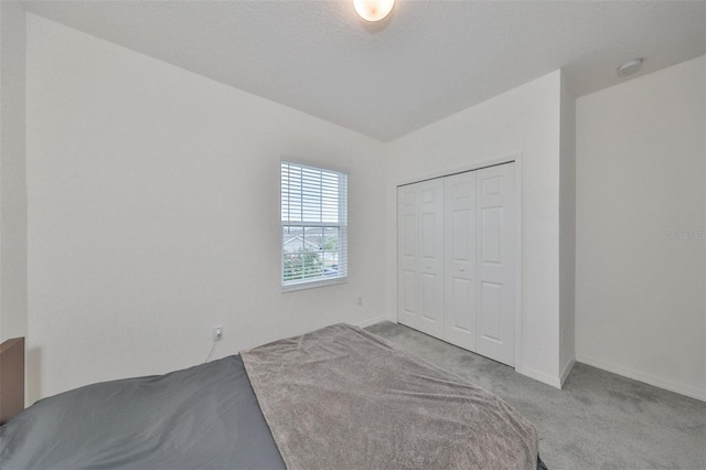 bedroom with a closet and light colored carpet