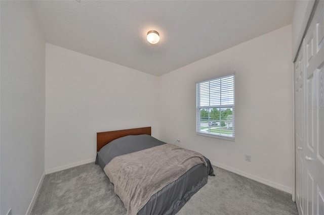 carpeted bedroom featuring a closet