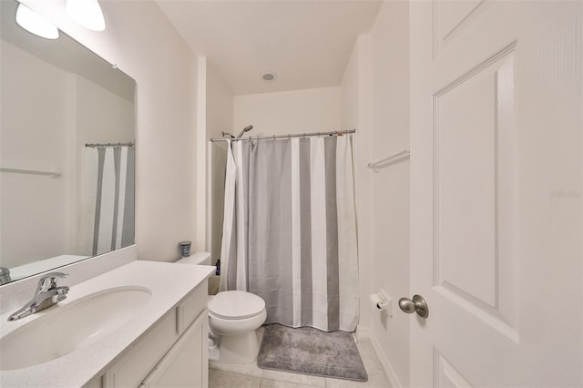 bathroom with a shower with shower curtain, vanity, toilet, and tile patterned floors