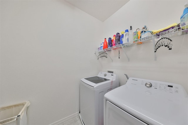 clothes washing area with washing machine and dryer