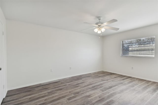 empty room featuring ceiling fan and hardwood / wood-style flooring