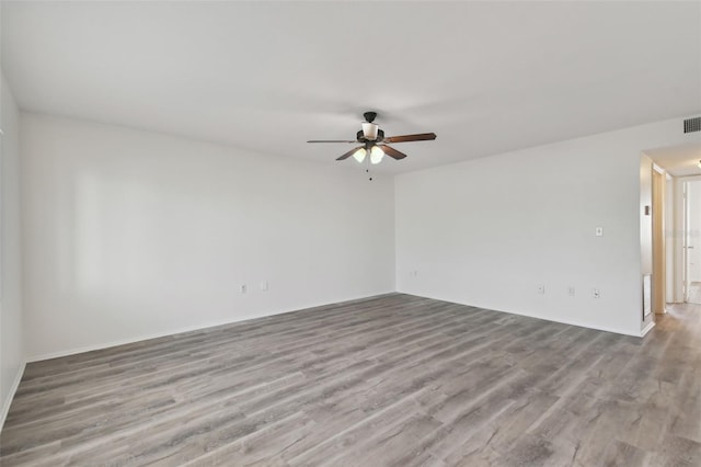 empty room with ceiling fan and light wood-type flooring