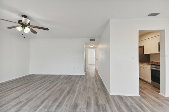 empty room featuring ceiling fan and light wood-type flooring