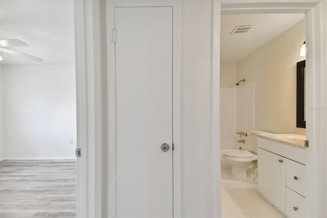 bathroom with ceiling fan, hardwood / wood-style flooring, vanity, and toilet