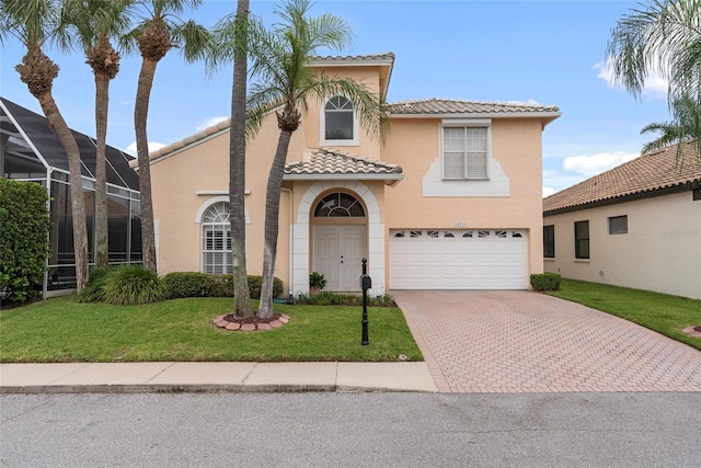 mediterranean / spanish home with glass enclosure, a garage, and a front lawn