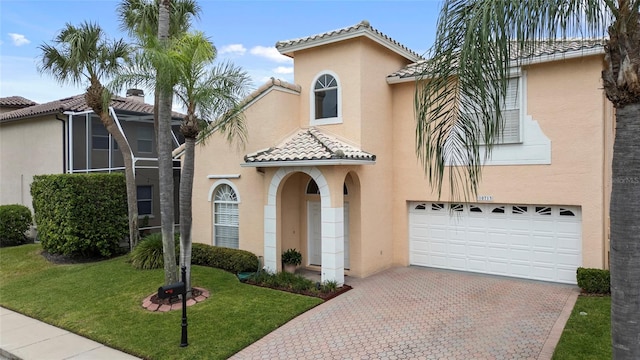 mediterranean / spanish-style house with a garage and a front lawn