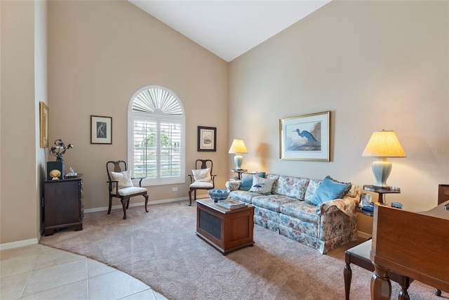 living room featuring high vaulted ceiling and light tile patterned flooring