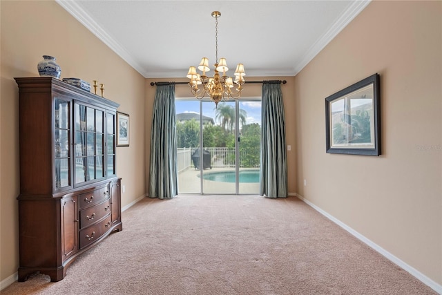 carpeted empty room featuring a healthy amount of sunlight, ornamental molding, and a chandelier