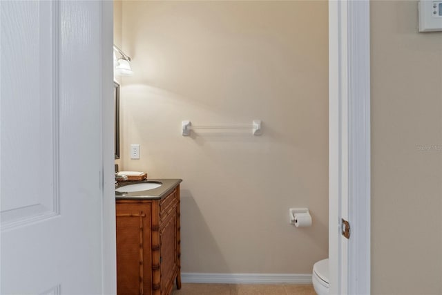 bathroom featuring tile patterned floors, toilet, and vanity