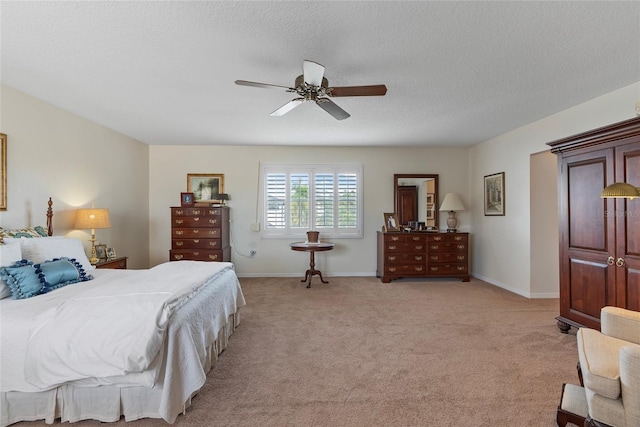 carpeted bedroom with a textured ceiling and ceiling fan