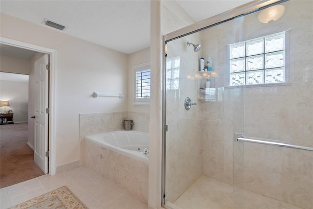 bathroom with independent shower and bath and tile patterned flooring