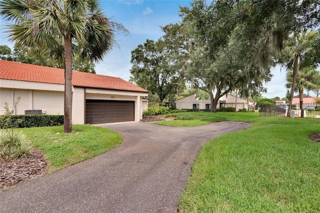 view of front of property featuring a garage and a front yard