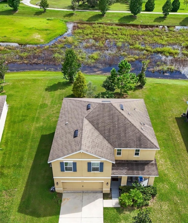 birds eye view of property with a water view
