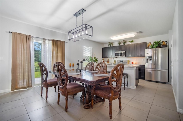 tiled dining space with an inviting chandelier and sink