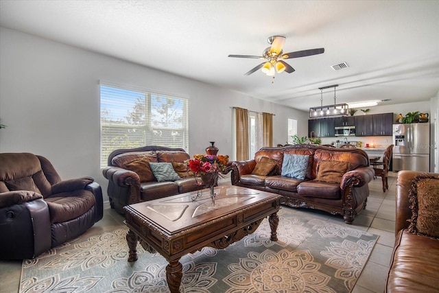 tiled living room featuring ceiling fan