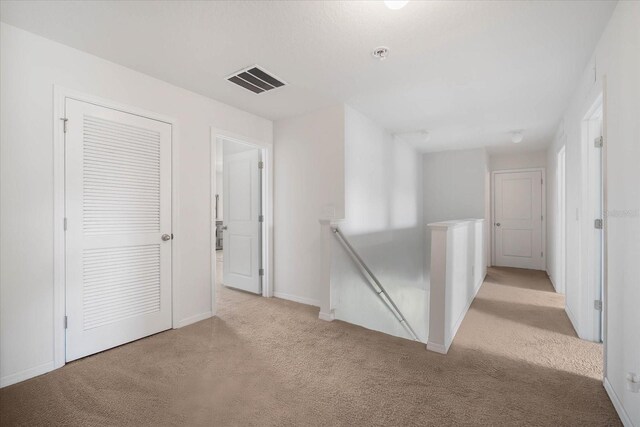 unfurnished room featuring light carpet