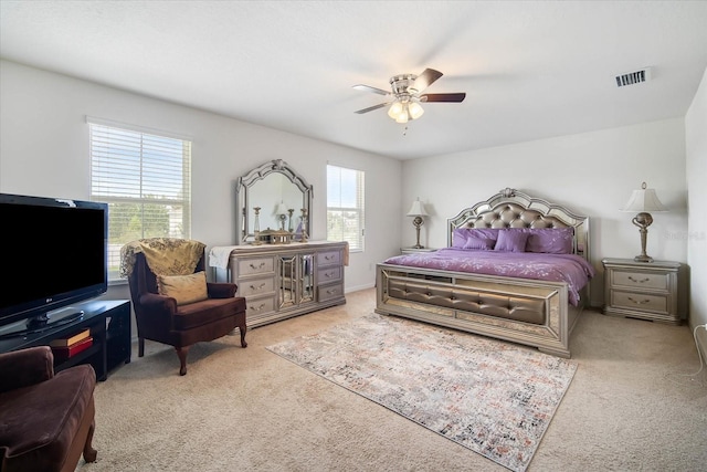bedroom with ceiling fan, visible vents, and carpet