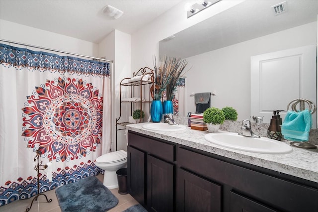 bathroom with tile patterned flooring, vanity, toilet, and walk in shower