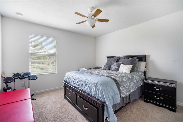 bedroom with light colored carpet, ceiling fan, and baseboards