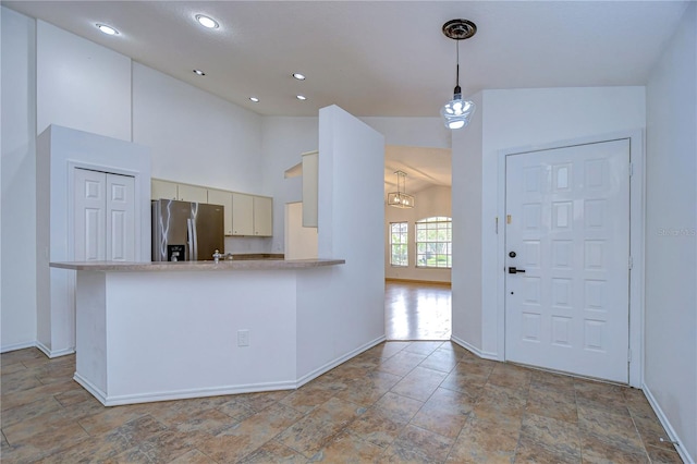 foyer entrance with lofted ceiling and a chandelier