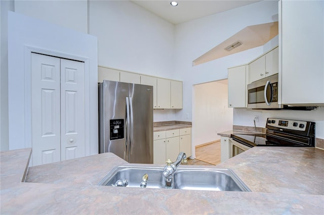 kitchen featuring white cabinetry, sink, and stainless steel appliances