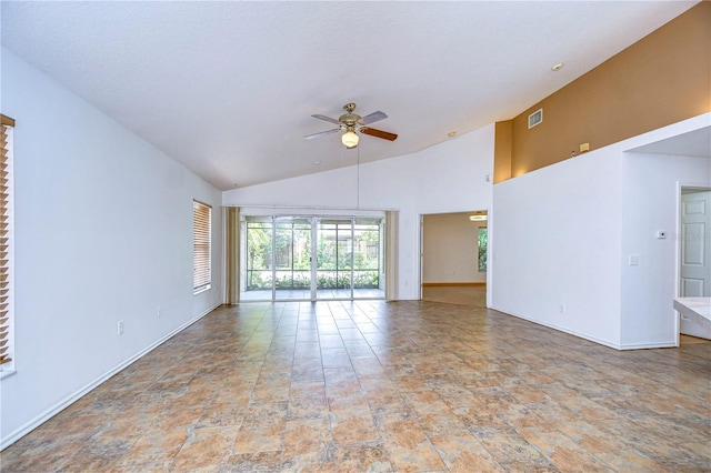 unfurnished living room featuring vaulted ceiling and ceiling fan