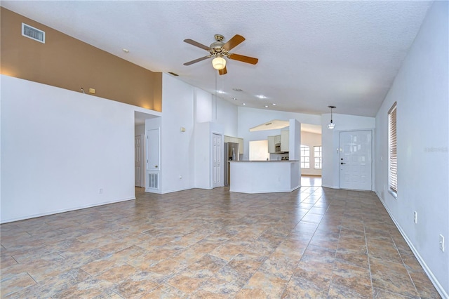 unfurnished living room featuring high vaulted ceiling, a textured ceiling, and ceiling fan