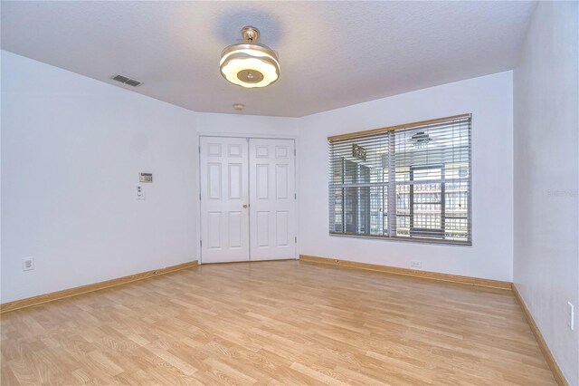 unfurnished room featuring light hardwood / wood-style floors