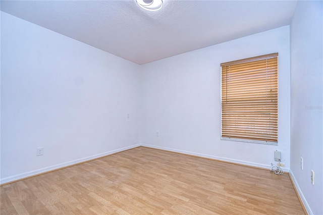 unfurnished room with light hardwood / wood-style floors