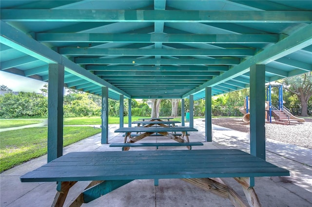 view of community featuring a patio area and a lawn