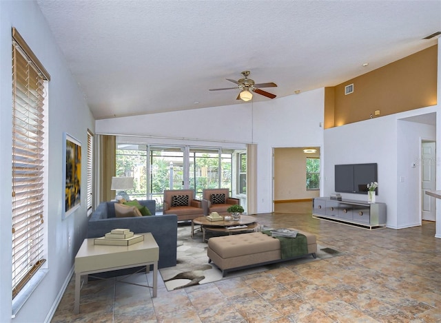 living room featuring ceiling fan, high vaulted ceiling, and a textured ceiling