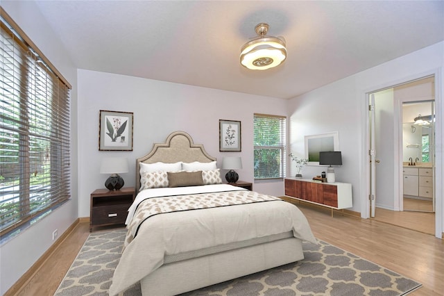 bedroom featuring sink and light hardwood / wood-style flooring