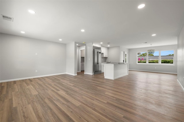 unfurnished living room with hardwood / wood-style flooring