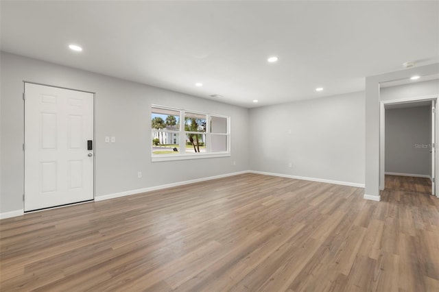 unfurnished living room featuring hardwood / wood-style flooring