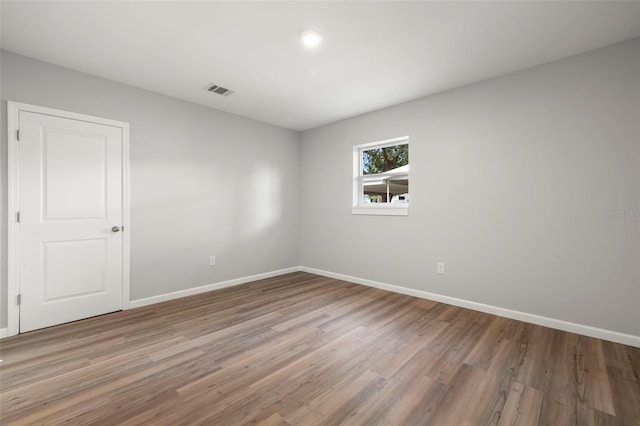 spare room with wood-type flooring