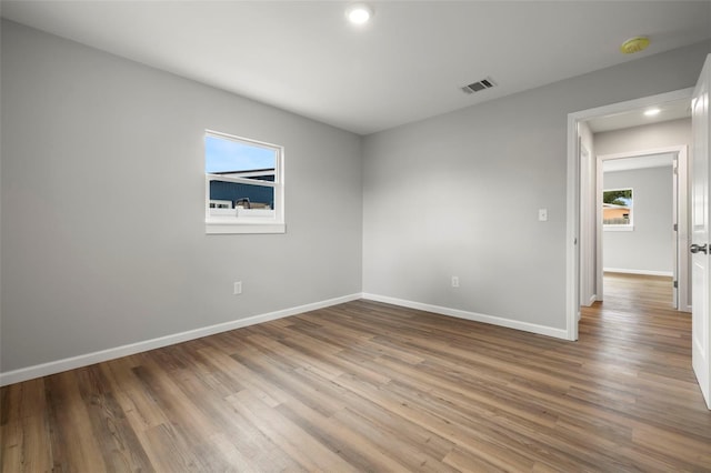 spare room featuring wood-type flooring