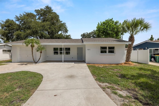 ranch-style home featuring a garage and a front lawn