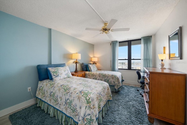 bedroom featuring ceiling fan and a textured ceiling