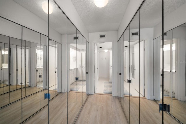 bathroom featuring hardwood / wood-style floors and a textured ceiling