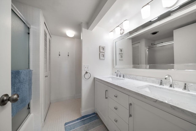 bathroom with vanity and bath / shower combo with glass door