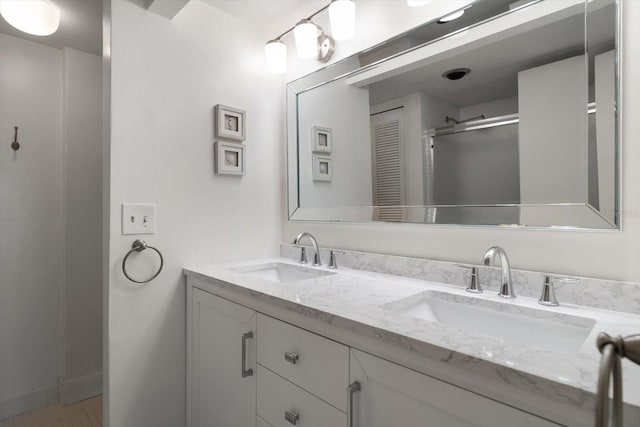 bathroom featuring vanity and a shower with shower door